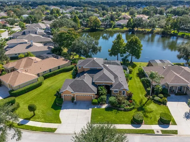an aerial view of a house with garden space and lake view