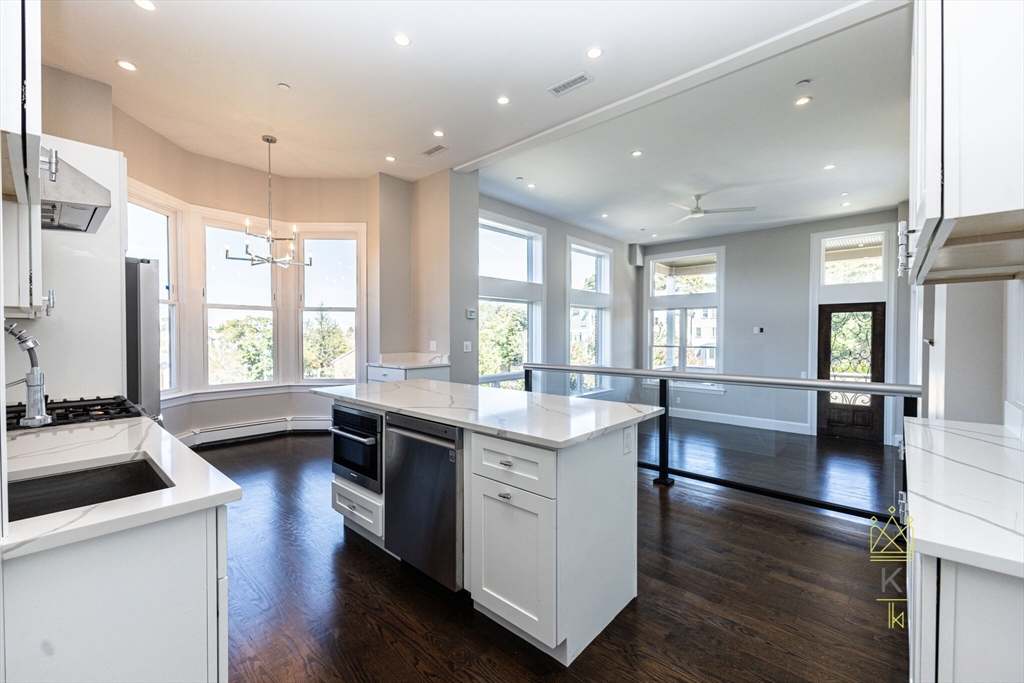 85 Regent Street, Unit 7 Boston, MA 02119 - Photo 1 of 22 a kitchen with stainless steel appliances a sink a stove a refrigerator cabinets and wooden floor