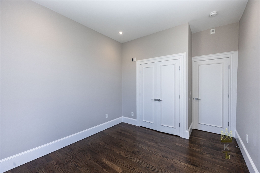 85 Regent Street, Unit 7 Boston, MA 02119 - Photo 18 of 22 a view of an empty room with wooden floor and closet