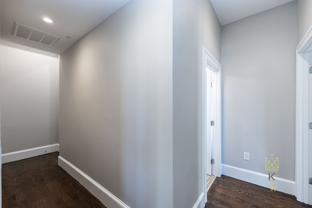 85 Regent Street, Unit 7 Boston, MA 02119 - Photo 20 of 22 a view of hallway with wooden floor