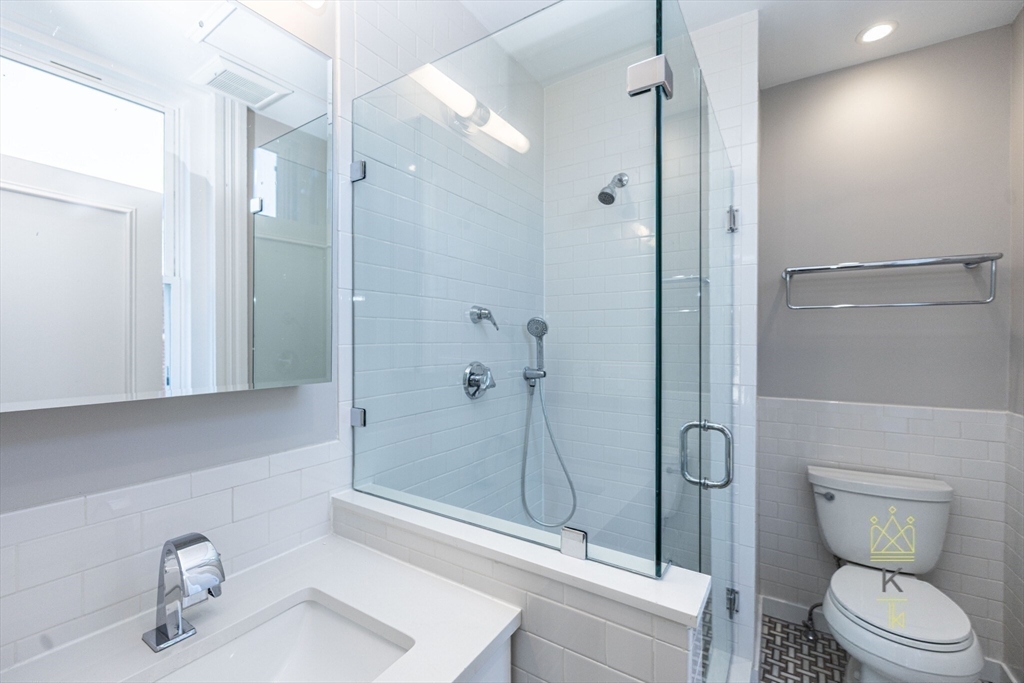 85 Regent Street, Unit 7 Boston, MA 02119 - Photo 21 of 22 a bathroom with a toilet and a sink