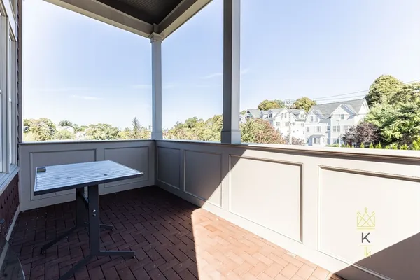 a view of a balcony with chairs and a table
