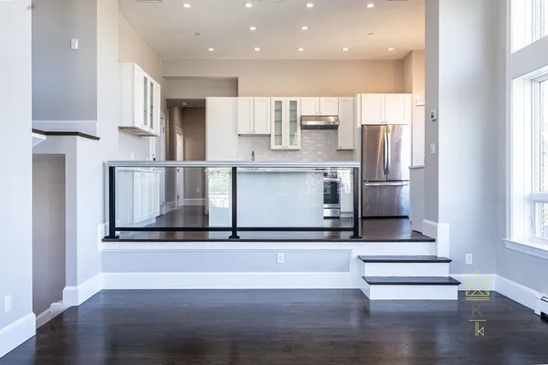 a kitchen with stainless steel appliances granite countertop a refrigerator and a stove top oven