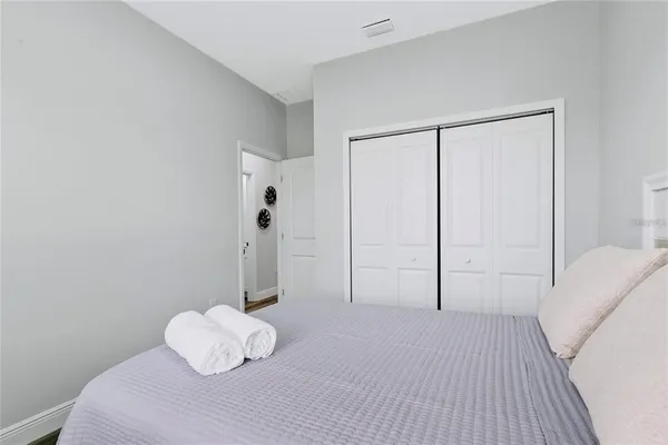 a bedroom with a bed and a potted plant