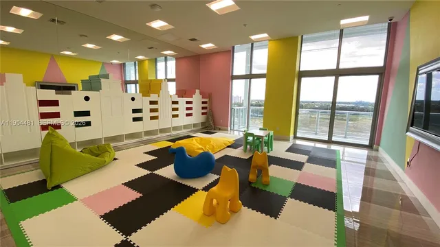 a living room with patio furniture and a large window