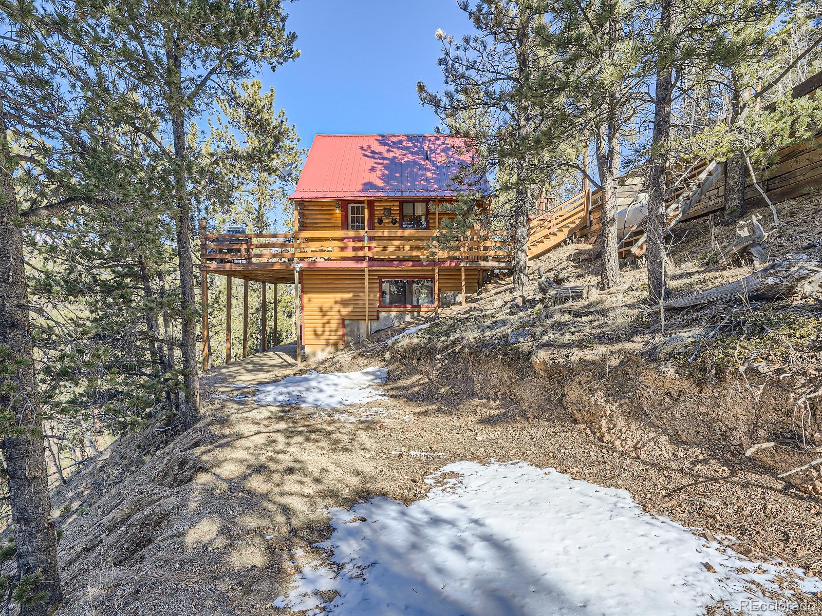 a view of a house with a yard covered with snow in the background