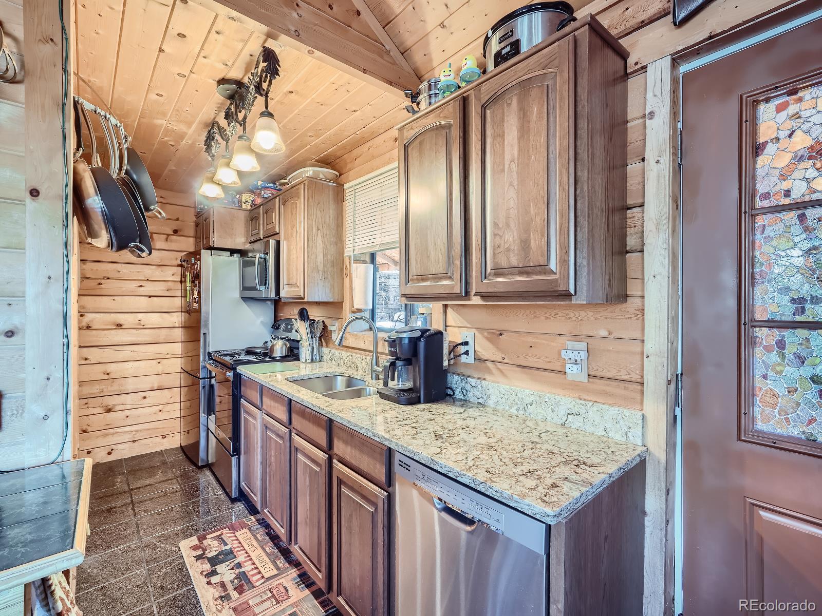 139 Hayes Street Bailey, CO 80421 - Photo 11 of 28 a kitchen with a sink stove and cabinets