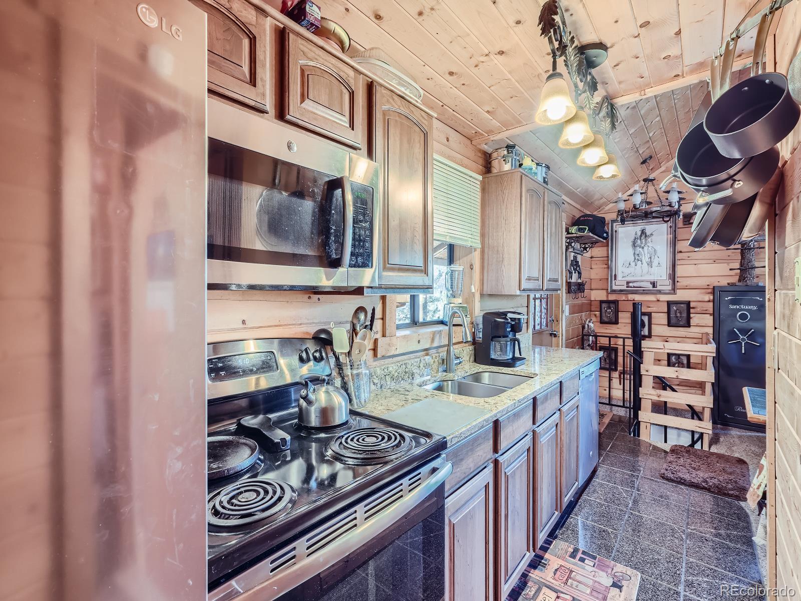 139 Hayes Street Bailey, CO 80421 - Photo 12 of 28 a kitchen with stainless steel appliances granite countertop a stove and a sink