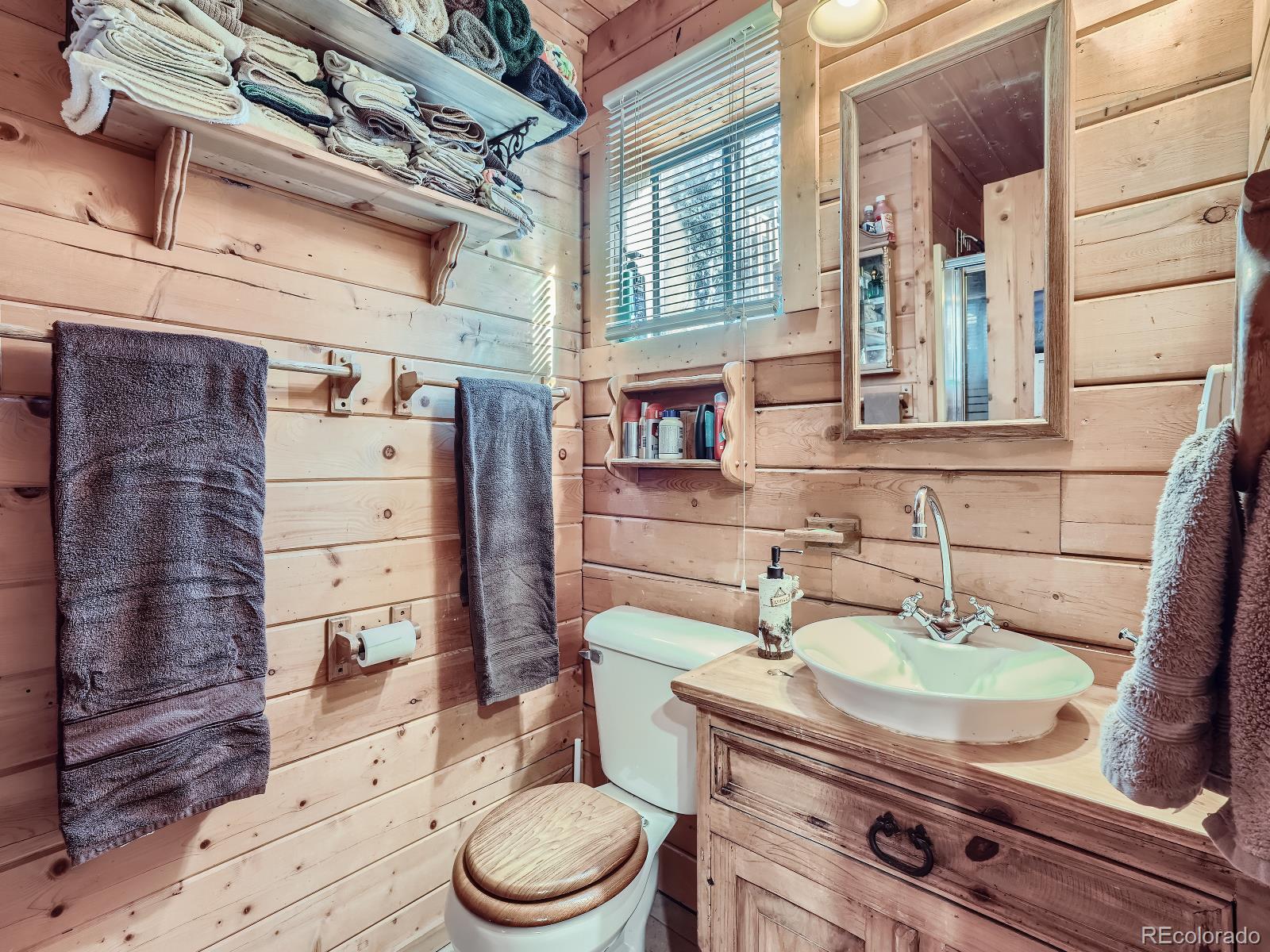 139 Hayes Street Bailey, CO 80421 - Photo 14 of 28 a bathroom with a granite countertop toilet sink and mirror