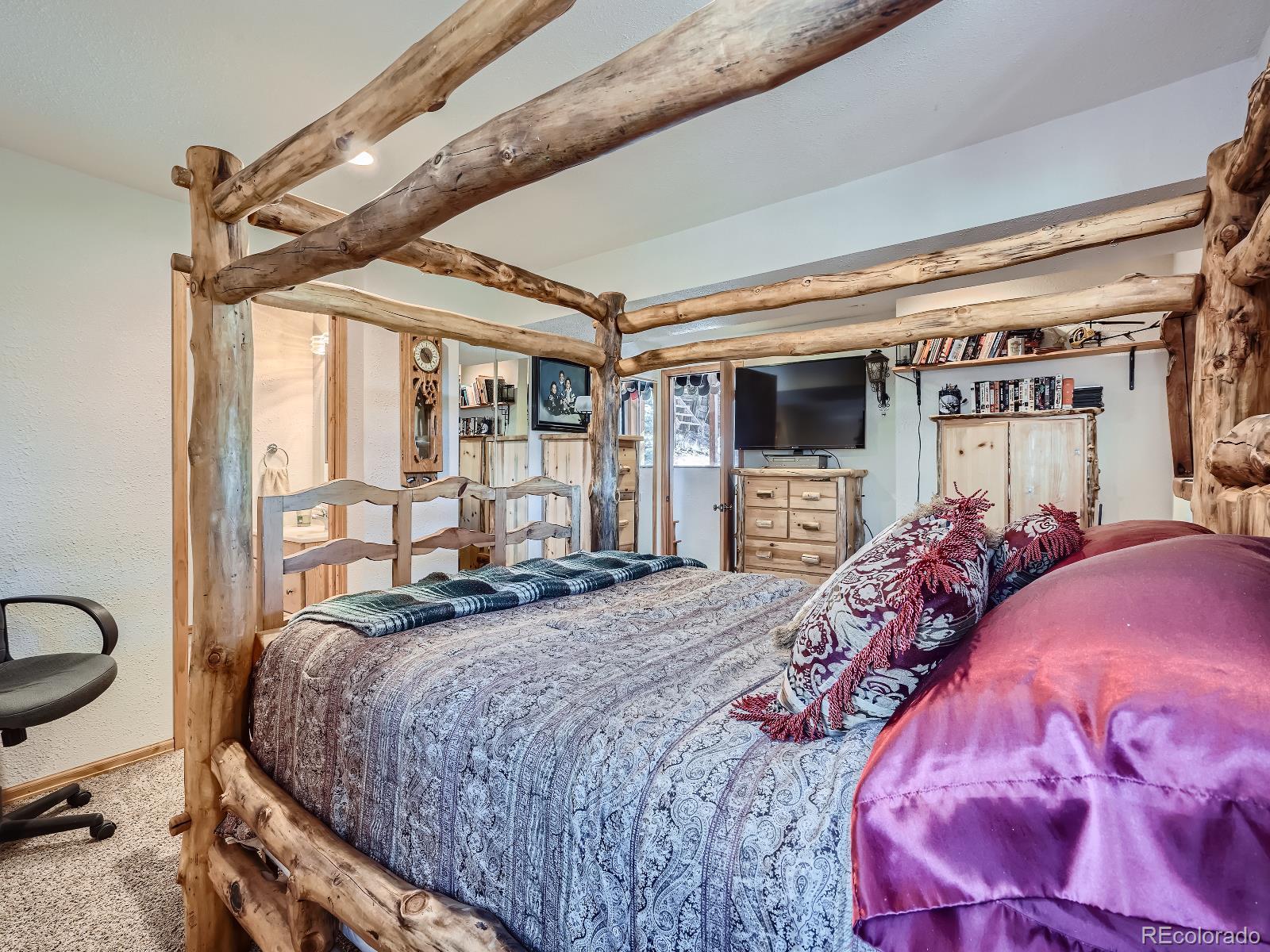 139 Hayes Street Bailey, CO 80421 - Photo 19 of 28 a bed sitting in a bedroom next to a window