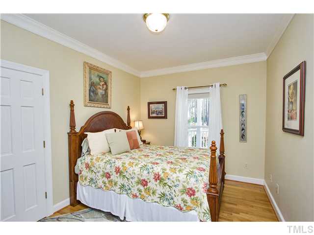 10117 Hampton Road Rougemont, NC 27572 - Photo 14 of 25 a bedroom with a bed and wooden floor