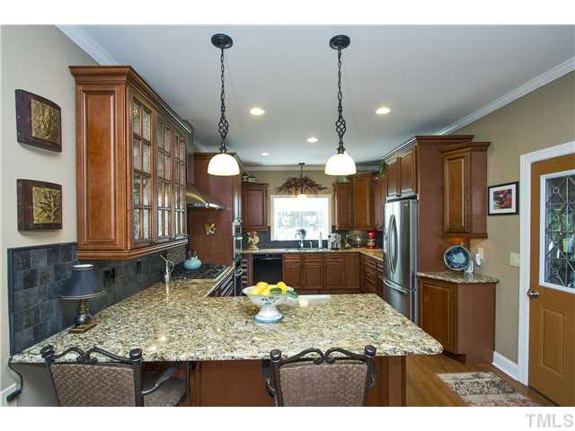 10117 Hampton Road Rougemont, NC 27572 - Photo 7 of 25 a kitchen with stainless steel appliances granite countertop a sink refrigerator and stove