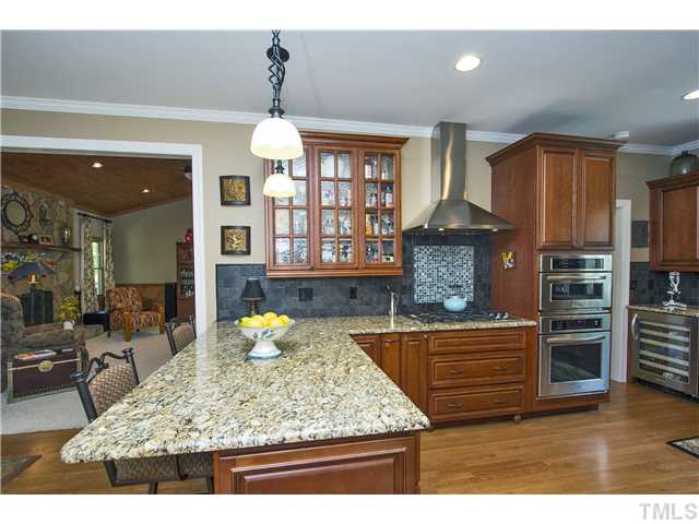 10117 Hampton Road Rougemont, NC 27572 - Photo 9 of 25 a kitchen with stainless steel appliances granite countertop a stove a sink and a wooden cabinets