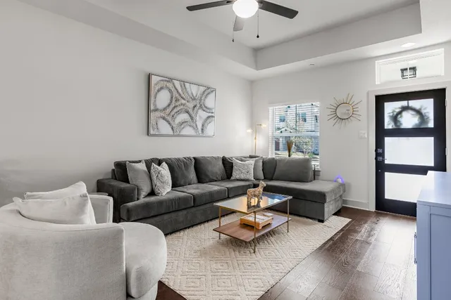 a living room with furniture and wooden floor