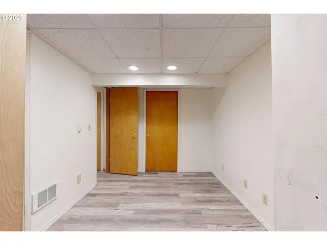 a view of hallway with wooden floor