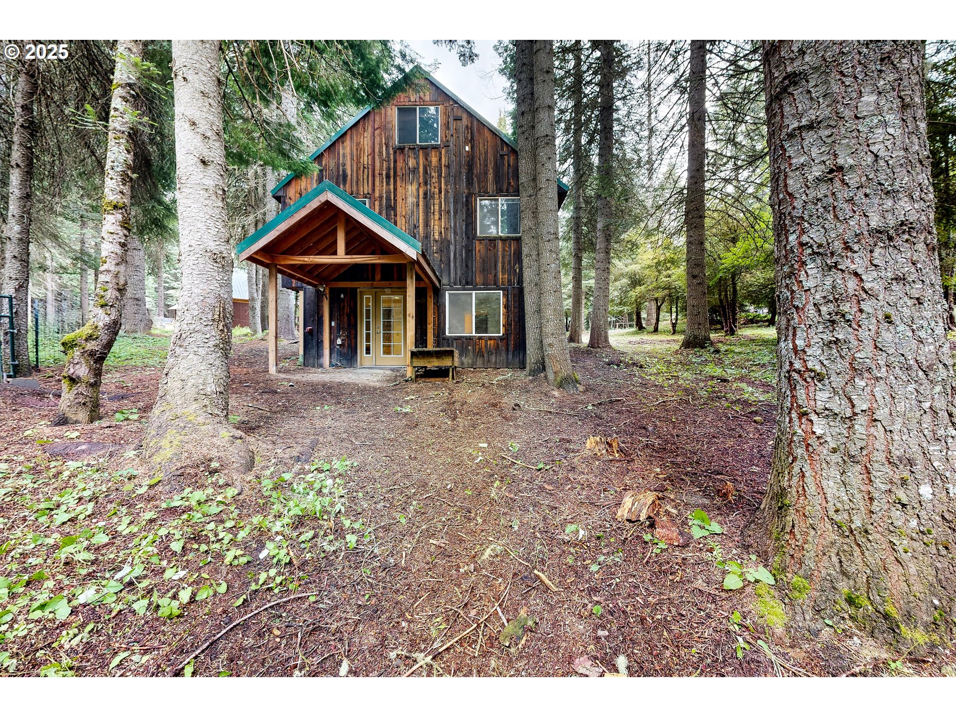 58504 Wildwood Loop Weston, OR 97886 - Photo 9 of 39 a view of wooden house with a yard and large trees