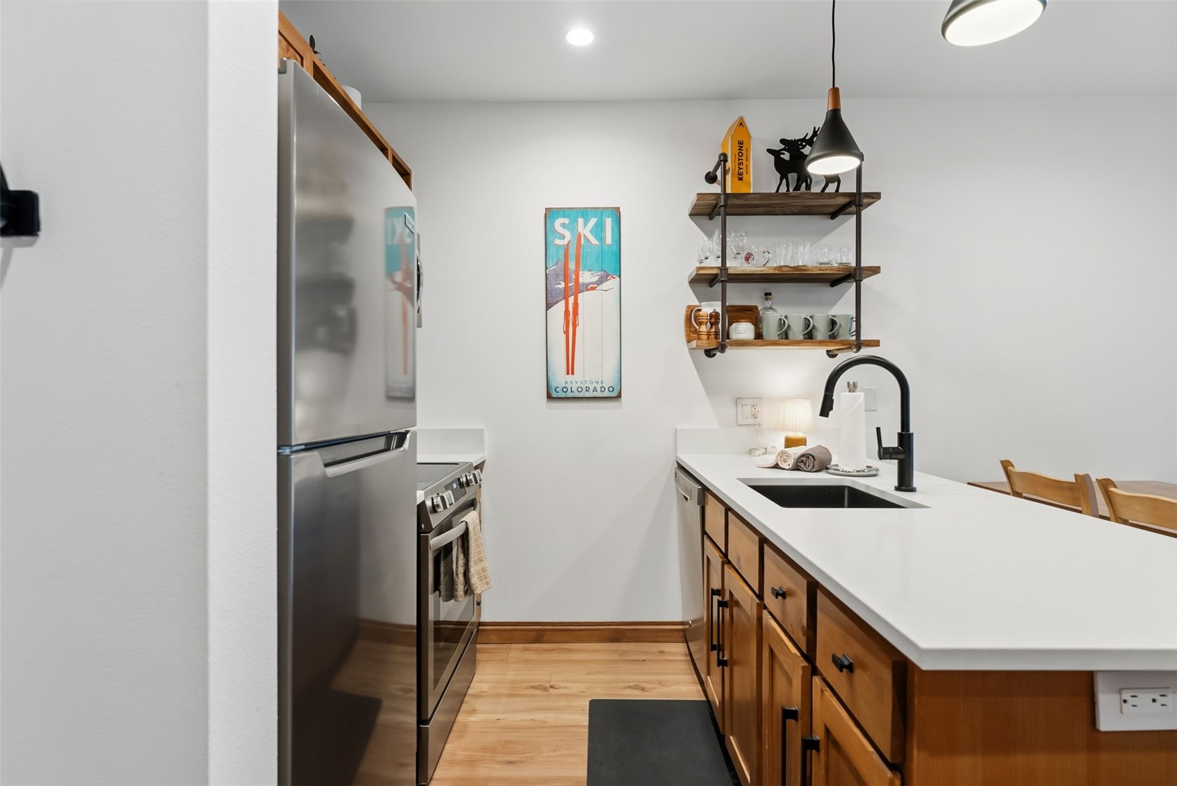 195 River Run Road, Unit 8015 Keystone, CO 80435 - Photo 11 of 35 a kitchen with stainless steel appliances granite countertop a sink and a refrigerator