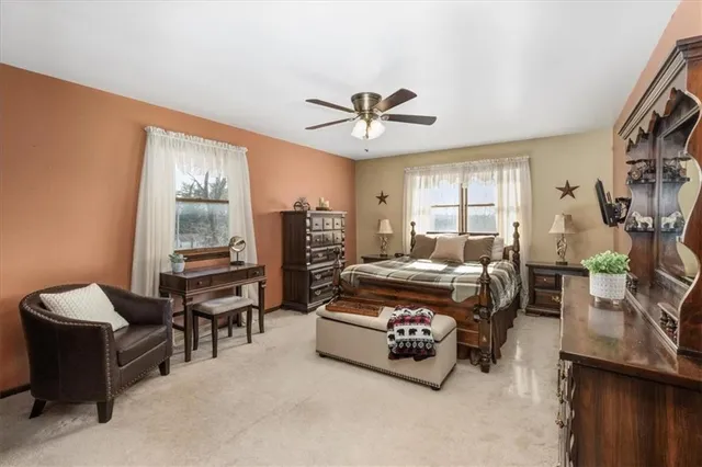 a living room with furniture a ceiling fan and a window