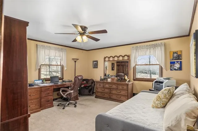 a view of a livingroom with workspace and a window