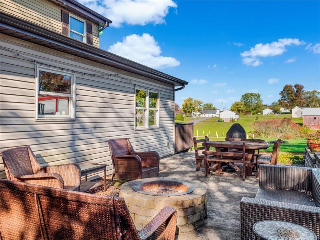 281 Bear Creek Road Sarver, PA 16055 - Photo 22 of 50 a view of a patio with dining table and chairs with wooden floor