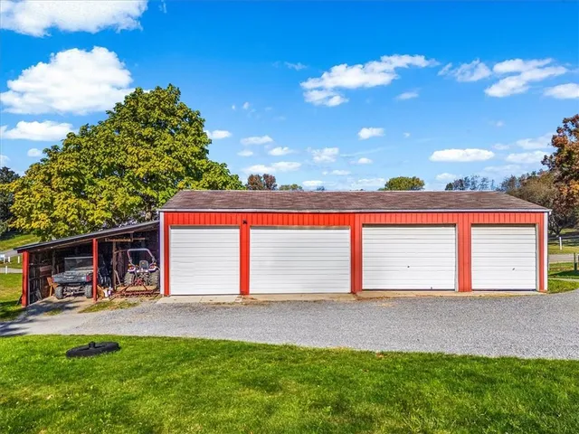 a view of a house with a backyard and sitting area