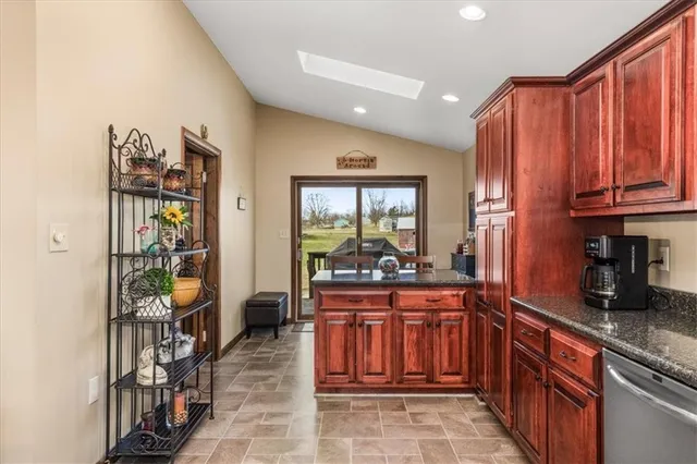a kitchen with lots of counter top space and wooden floor