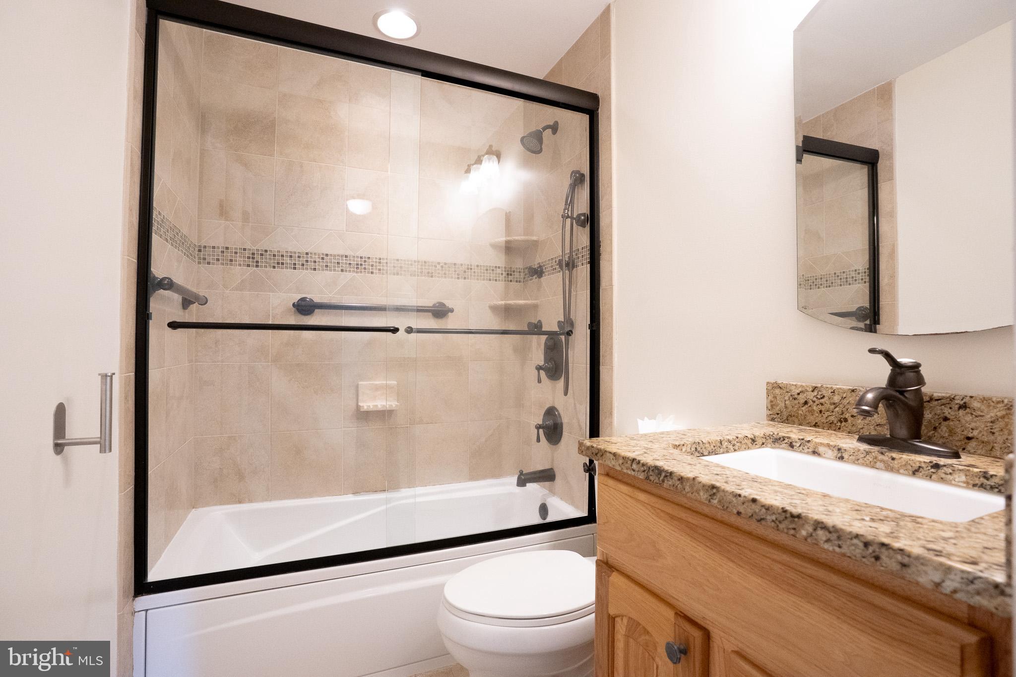 1318 Wickell Road Odenton, MD 21113 - Photo 15 of 23 a bathroom with a granite countertop sink mirror vanity and toilet