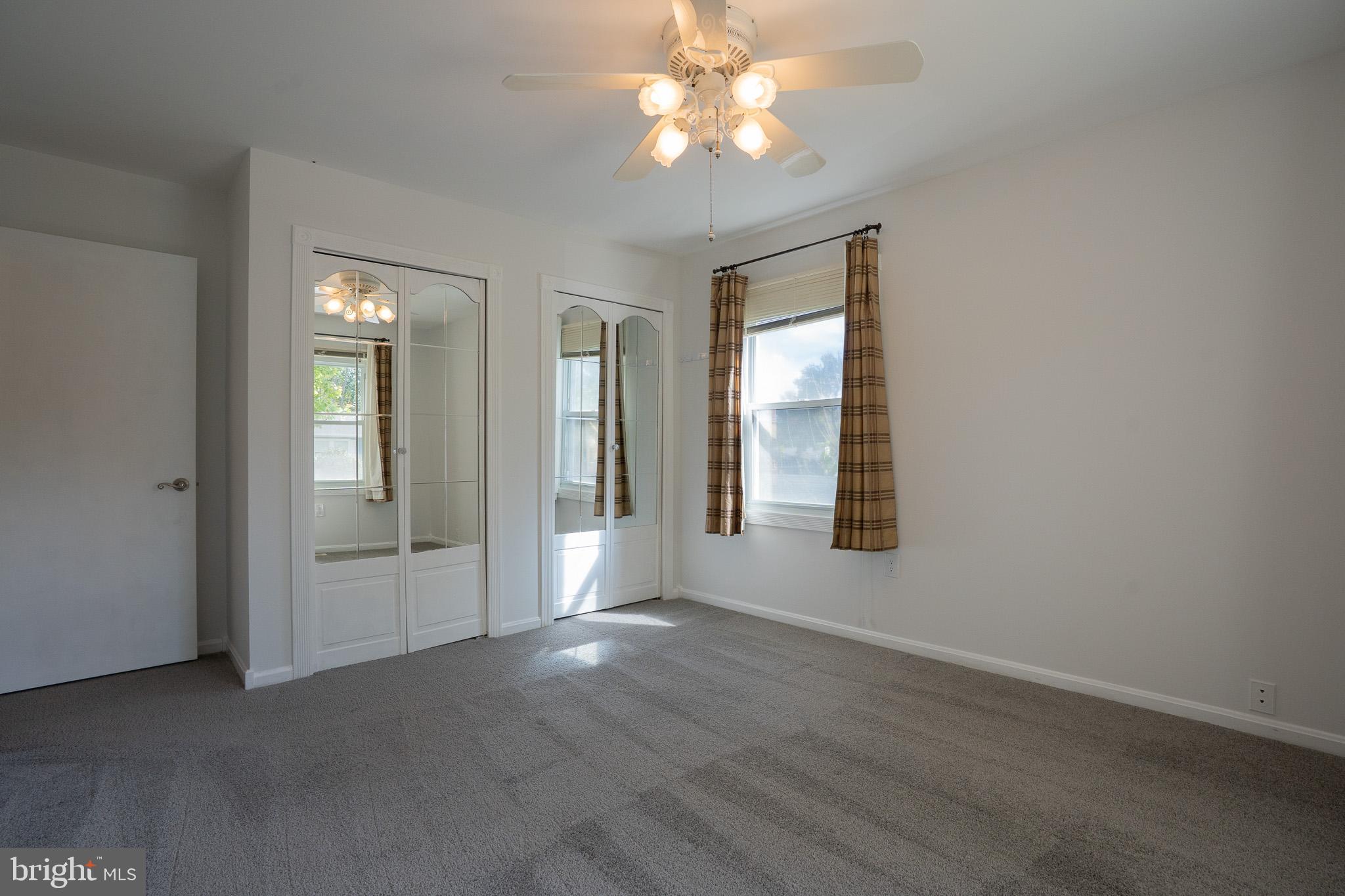 1318 Wickell Road Odenton, MD 21113 - Photo 16 of 23 an empty room with chandelier fan and windows