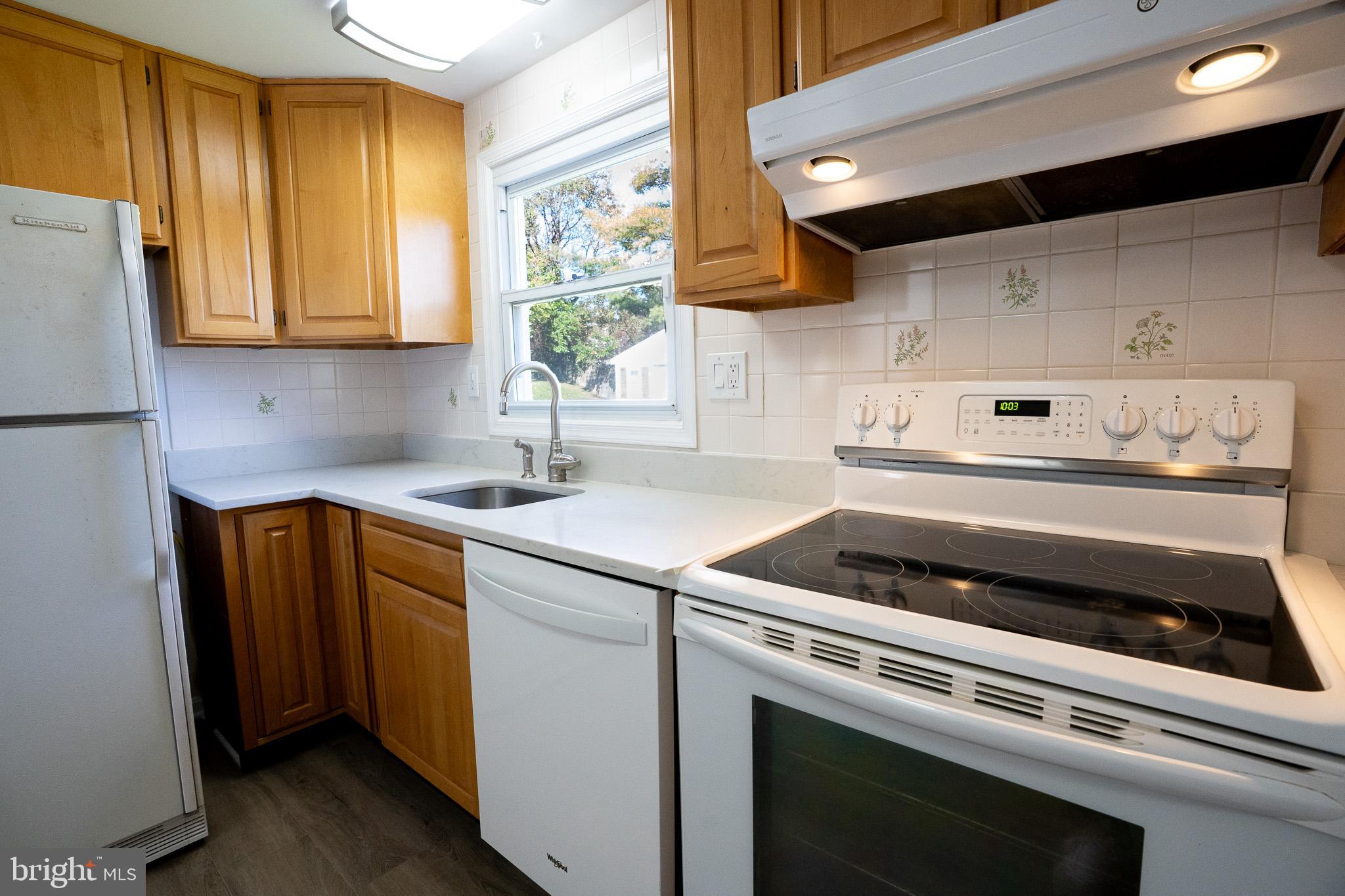 1318 Wickell Road Odenton, MD 21113 - Photo 7 of 23 a kitchen with a stove and a refrigerator