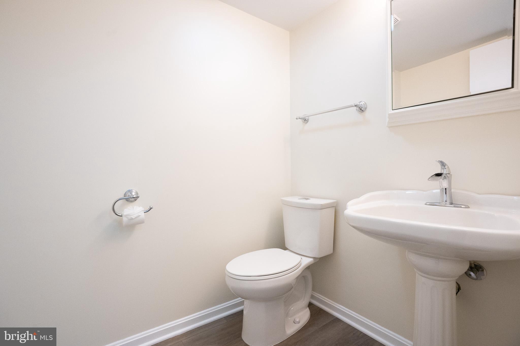 1318 Wickell Road Odenton, MD 21113 - Photo 10 of 23 a bathroom with a sink a toilet and a mirror