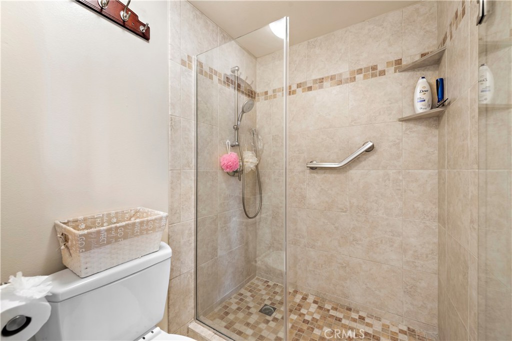 1205 Via Catalina San Clemente, CA 92672 - Photo 16 of 42 a bathroom with a granite countertop shower and a toilet
