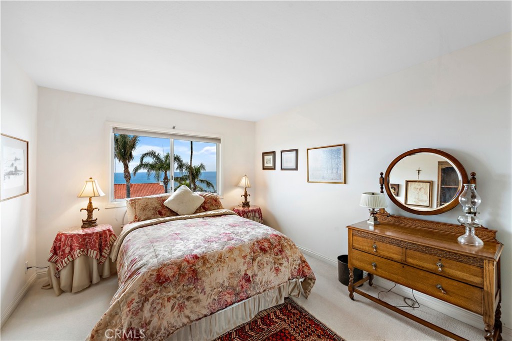 1205 Via Catalina San Clemente, CA 92672 - Photo 21 of 42 a bed room with a bed a mirror and a table