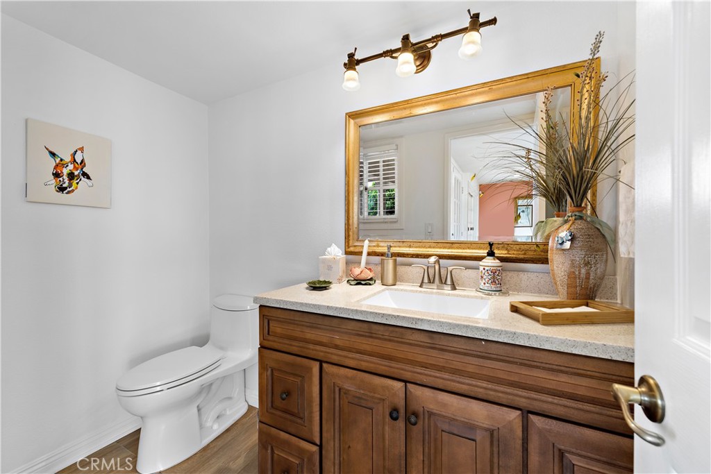 1205 Via Catalina San Clemente, CA 92672 - Photo 26 of 42 a bathroom with a toilet a sink and mirror
