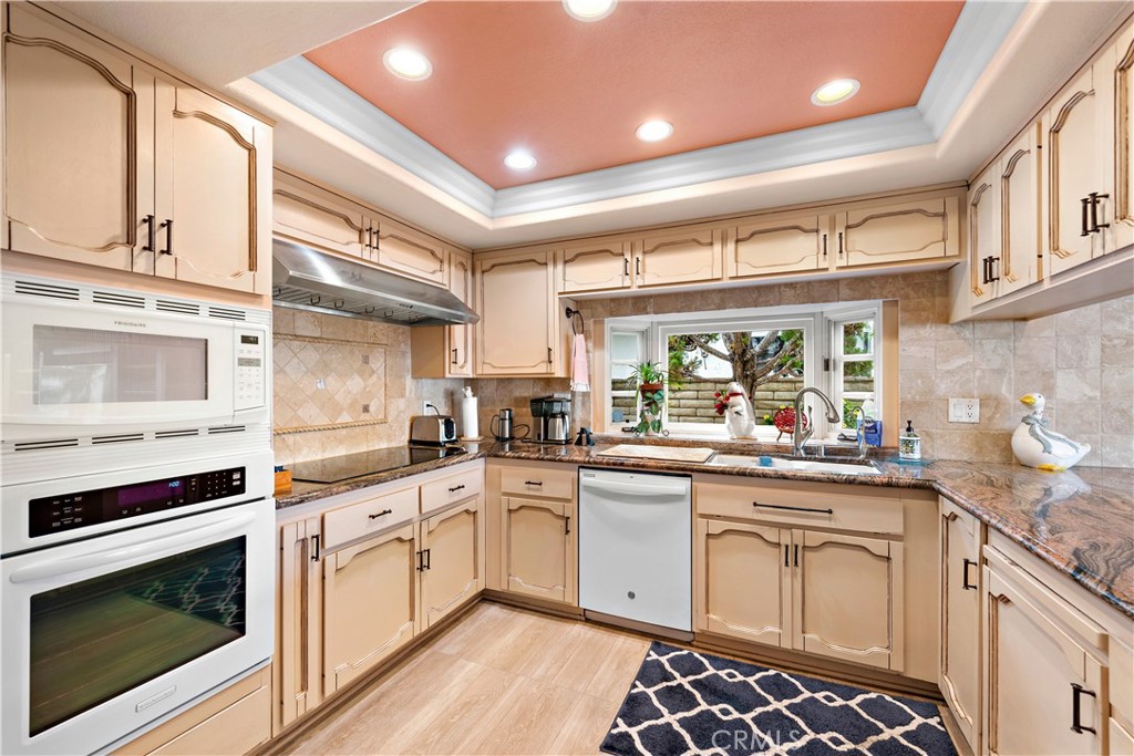 1205 Via Catalina San Clemente, CA 92672 - Photo 7 of 42 a kitchen with a sink stove top oven and cabinets