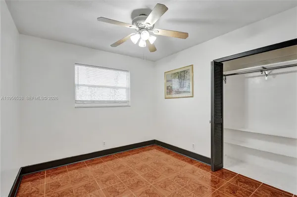 a view of an empty room with a ceiling fan