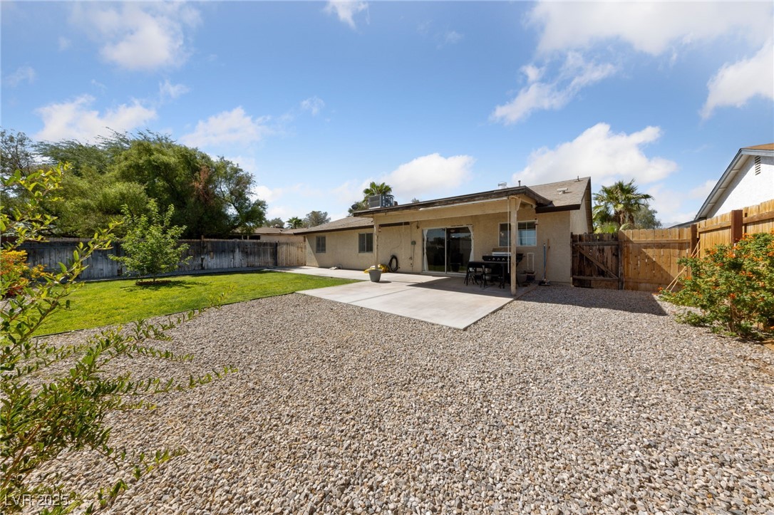 2637 Rialto Road Las Vegas, NV 89108 - Photo 21 of 22 Rear view of property featuring a fenced backyard, a yard, a gate, stucco siding, and a patio area
