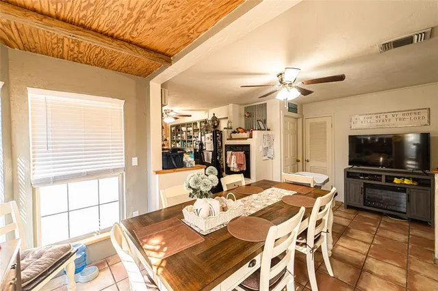 a view of a dining room with furniture and a flat screen tv