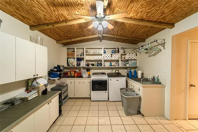 a room with stainless steel appliances kitchen island granite countertop furniture and a refrigerator