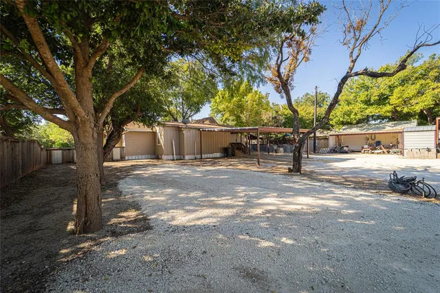 a view of a patio with a table and chairs under an umbrella