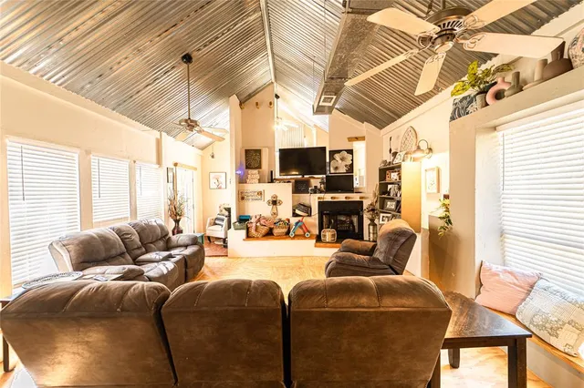 a living room with furniture a flat screen tv and a window