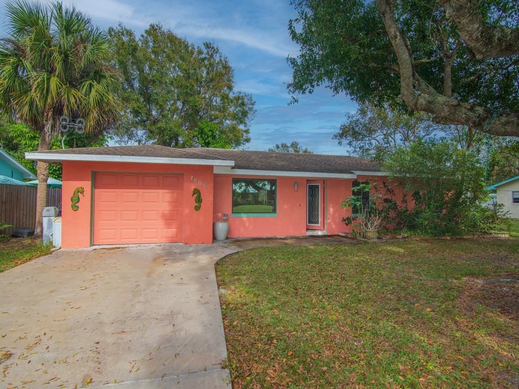 7506 Donlon Road Fort Pierce, FL 34951 - Photo 1 of 23 front view of a house with a yard