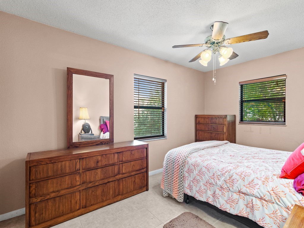 7506 Donlon Road Fort Pierce, FL 34951 - Photo 11 of 23 a bedroom with a bed and a dresser