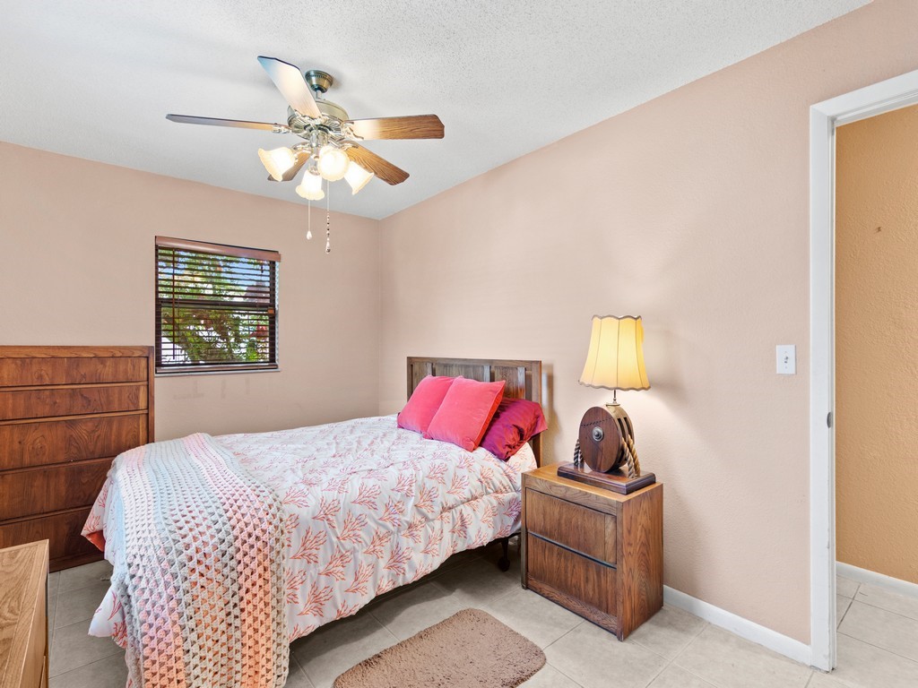 7506 Donlon Road Fort Pierce, FL 34951 - Photo 12 of 23 a bedroom with a bed and window