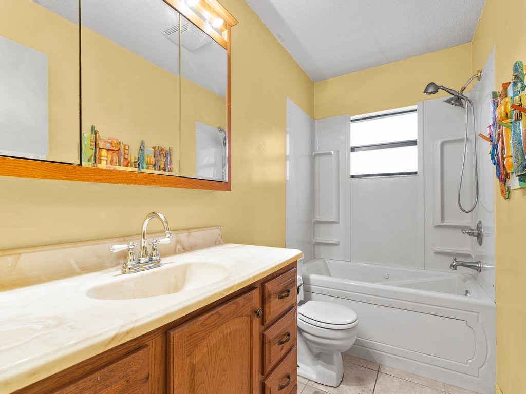 7506 Donlon Road Fort Pierce, FL 34951 - Photo 13 of 23 a bathroom with a sink a toilet and shower