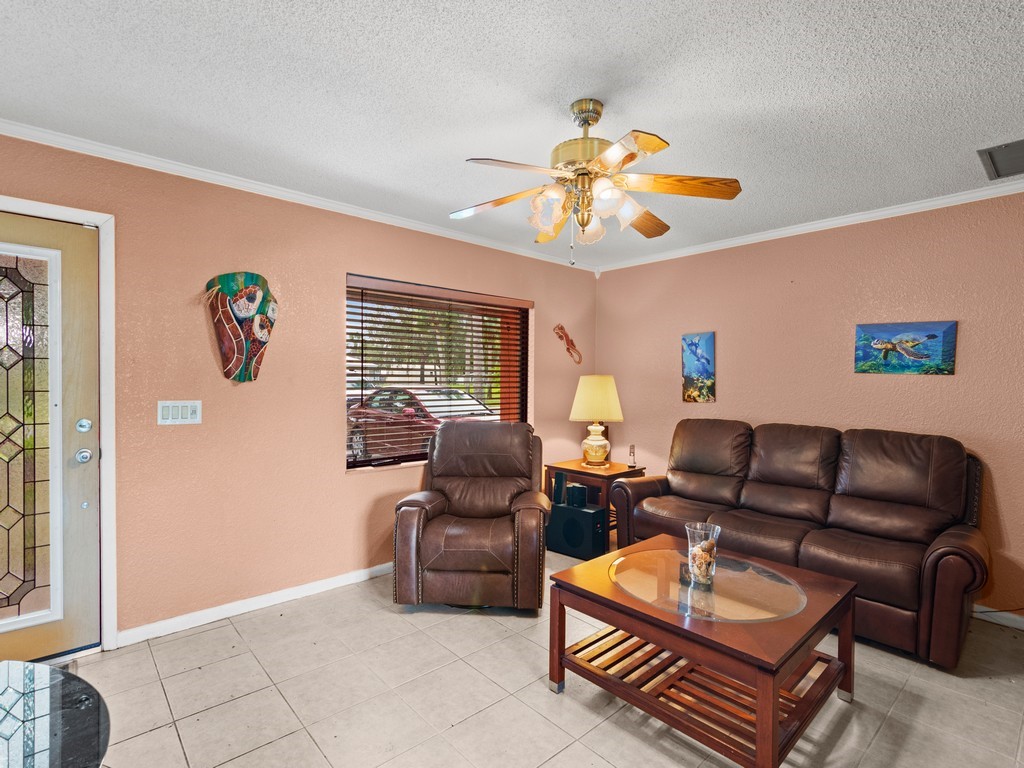 7506 Donlon Road Fort Pierce, FL 34951 - Photo 2 of 23 a living room with furniture a couch and a chandelier