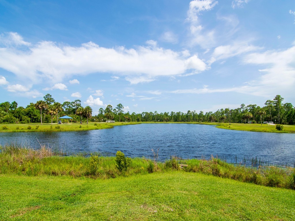 7506 Donlon Road Fort Pierce, FL 34951 - Photo 23 of 23 a view of a lake with houses in the back