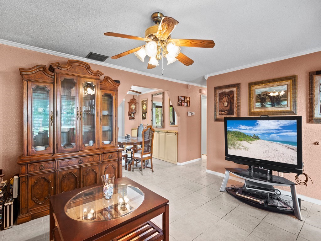 7506 Donlon Road Fort Pierce, FL 34951 - Photo 3 of 23 a living room with furniture and a flat screen tv