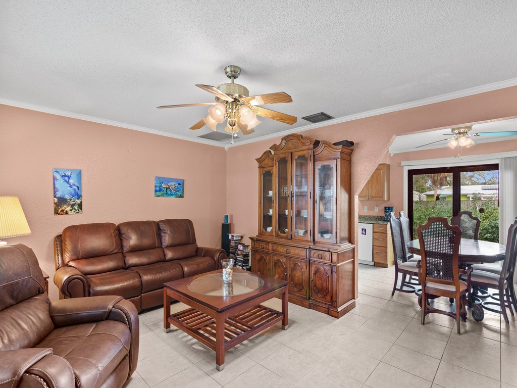 7506 Donlon Road Fort Pierce, FL 34951 - Photo 5 of 23 a living room with furniture a dining table and a piano table