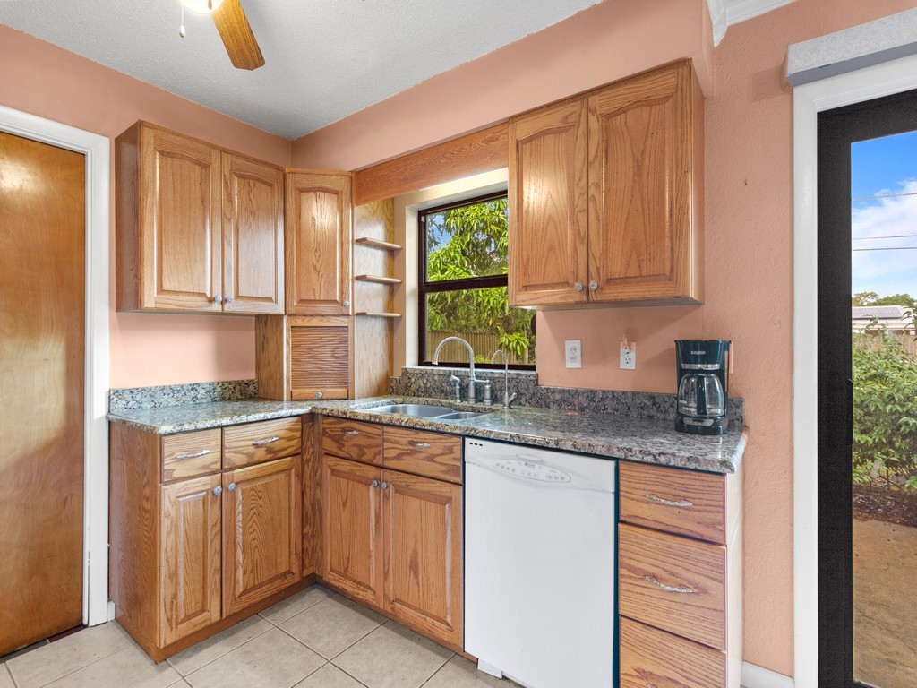 7506 Donlon Road Fort Pierce, FL 34951 - Photo 9 of 23 a kitchen with a sink cabinets and window