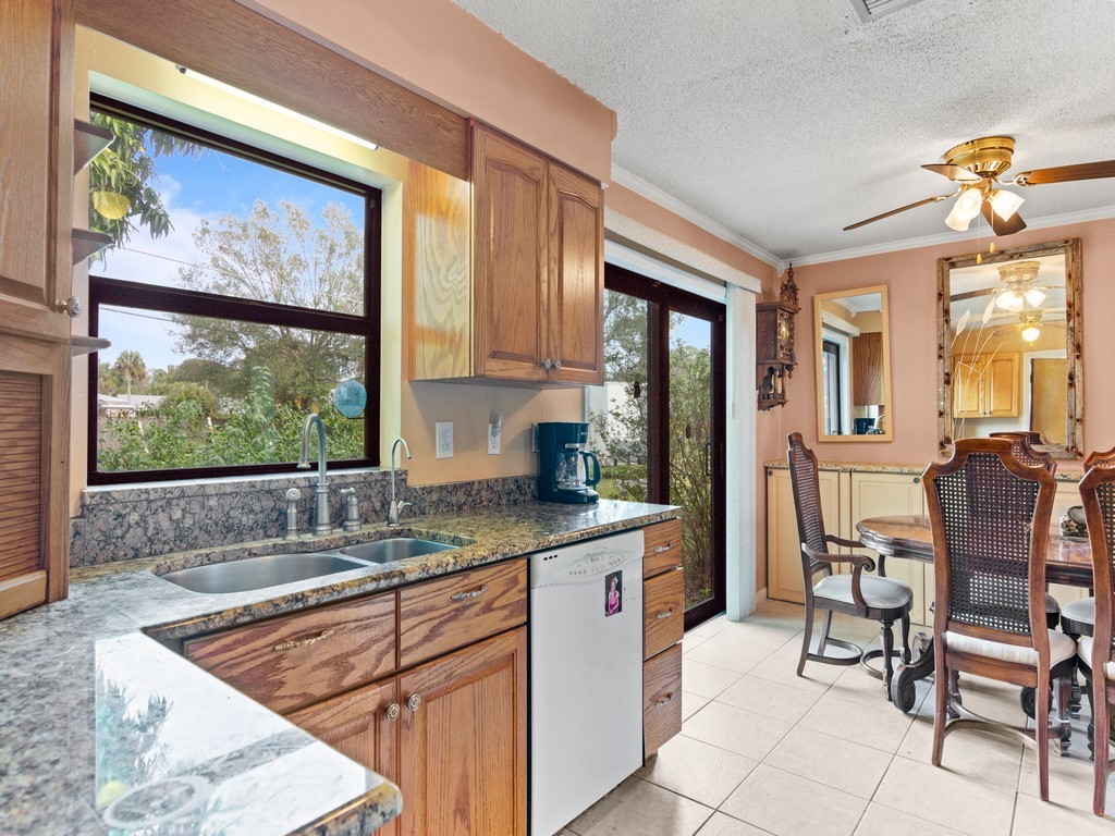 7506 Donlon Road Fort Pierce, FL 34951 - Photo 10 of 23 a dining room with a large window and chairs